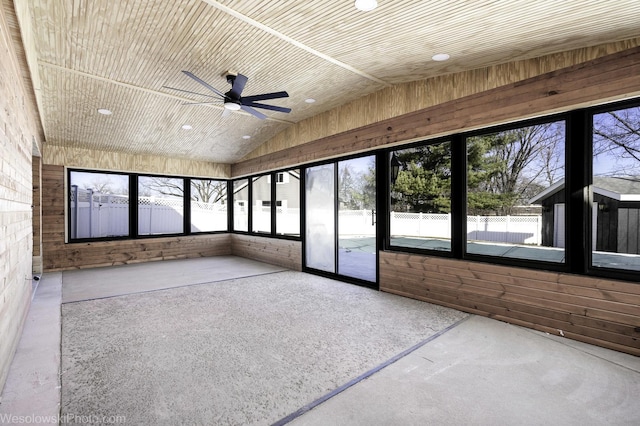 unfurnished sunroom with wood ceiling, ceiling fan, and lofted ceiling