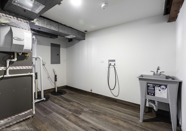 basement with dark wood-type flooring and electric panel