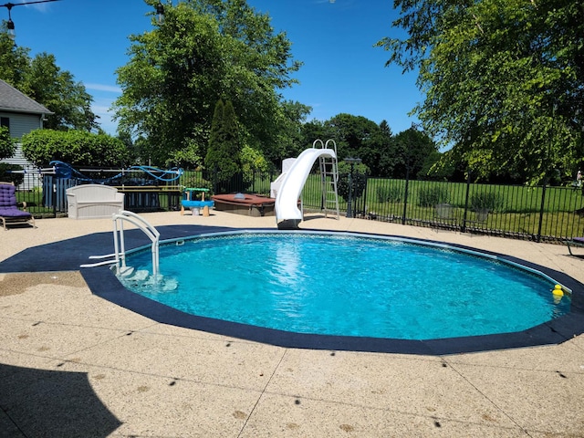 view of pool with sink, a hot tub, a patio, and a water slide