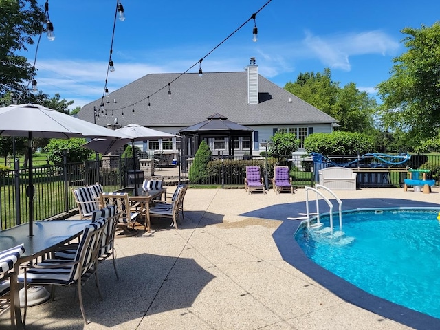 view of swimming pool featuring a gazebo and a patio