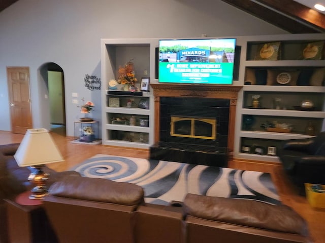 living room with built in shelves and wood-type flooring