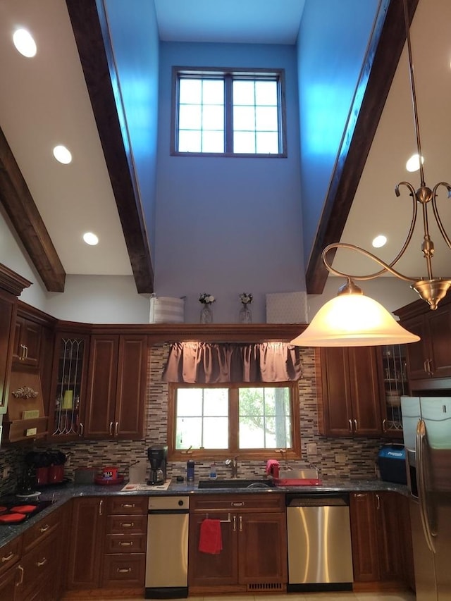 kitchen featuring tasteful backsplash, pendant lighting, beam ceiling, and stainless steel appliances