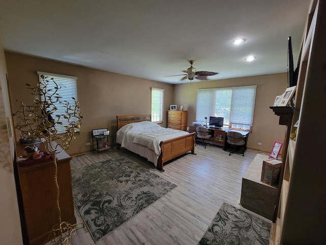 bedroom with ceiling fan and light hardwood / wood-style flooring