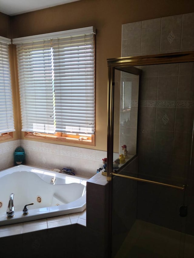 bathroom featuring shower with separate bathtub