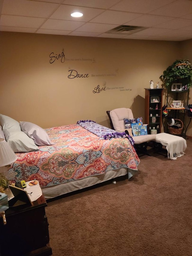 bedroom featuring a paneled ceiling and carpet