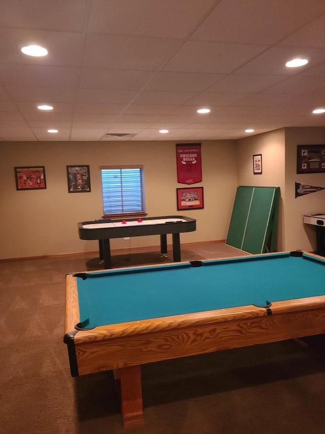 rec room featuring carpet and a drop ceiling