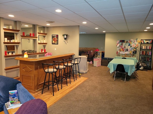 bar featuring carpet floors and a drop ceiling