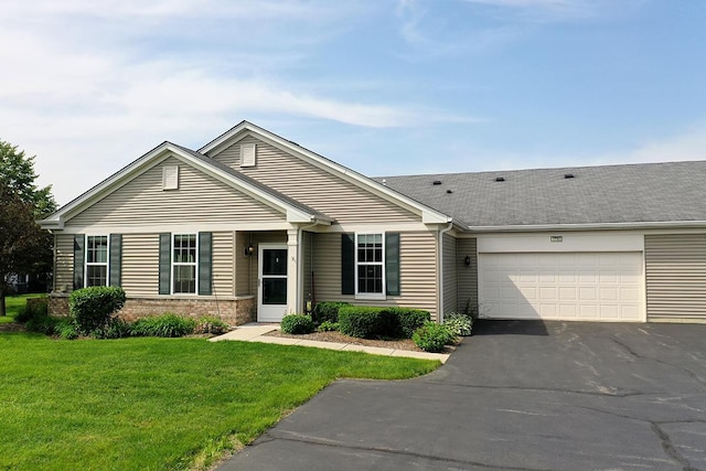 view of front of property featuring a garage and a front lawn