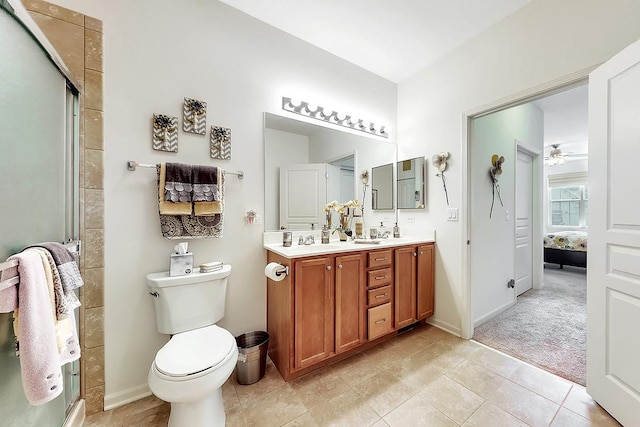 bathroom with vanity, walk in shower, ceiling fan, and toilet