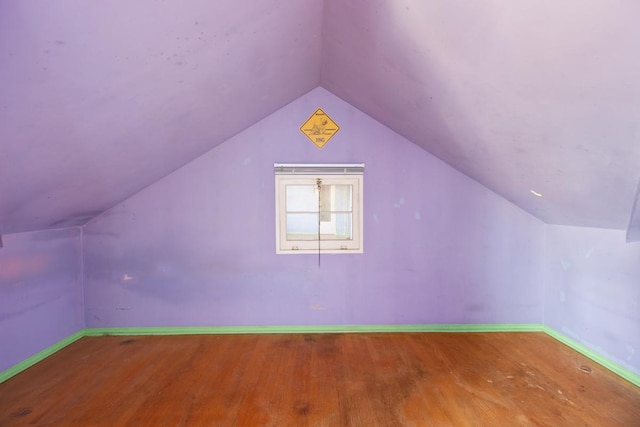 bonus room with lofted ceiling and hardwood / wood-style floors