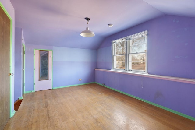 bonus room featuring lofted ceiling and light wood-type flooring