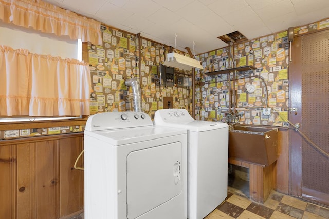 clothes washing area with sink and washer and clothes dryer