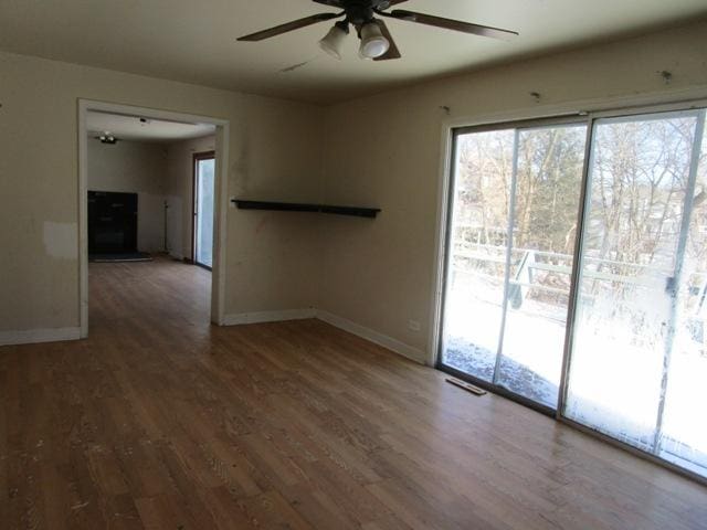 unfurnished room with hardwood / wood-style flooring and ceiling fan