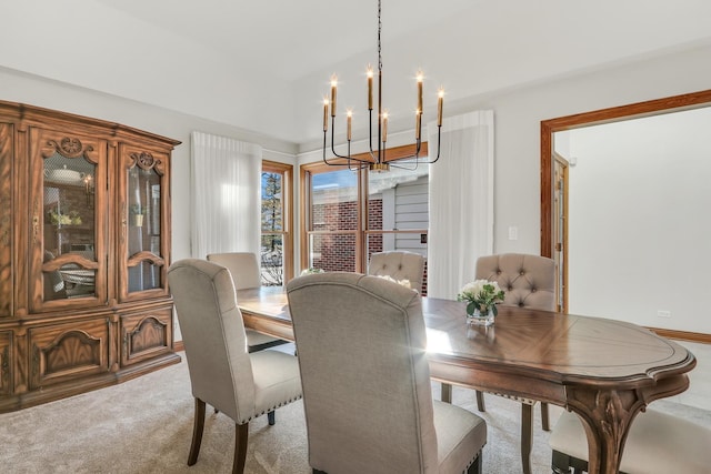 carpeted dining space with a notable chandelier