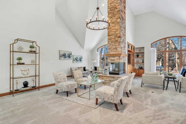 living room featuring an inviting chandelier, a stone fireplace, light colored carpet, and high vaulted ceiling