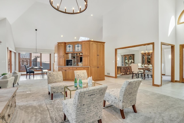 carpeted living room featuring a towering ceiling and a chandelier