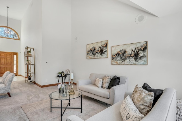 carpeted living room featuring a high ceiling