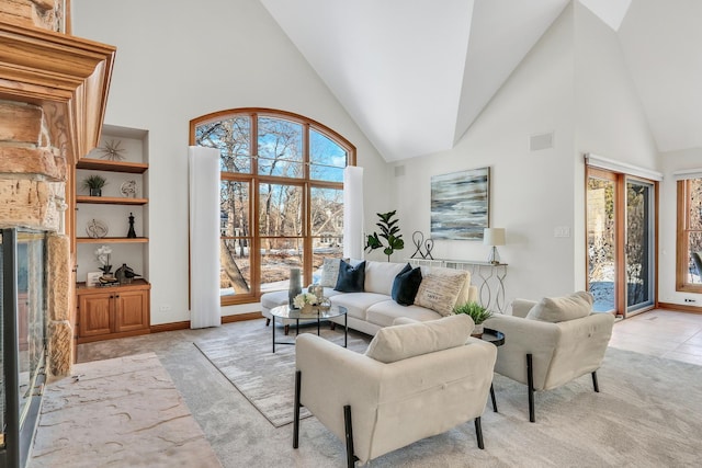 living room with built in features, light colored carpet, and a high ceiling