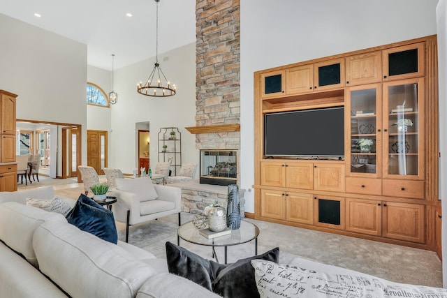 carpeted living room with an inviting chandelier, built in shelves, a fireplace, and a high ceiling