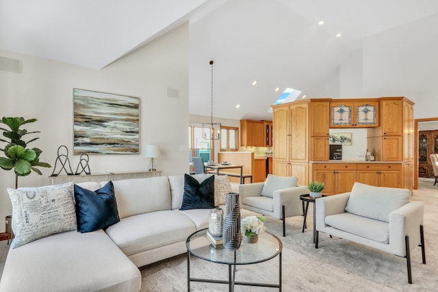 living room featuring an inviting chandelier and high vaulted ceiling