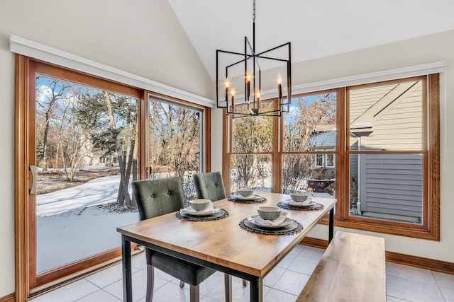 tiled dining room featuring lofted ceiling and a chandelier