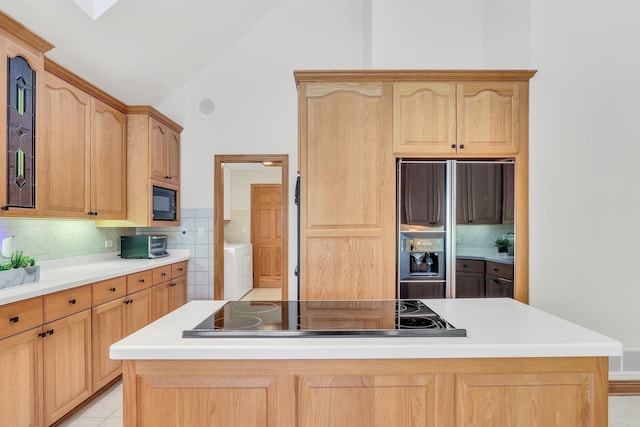 kitchen featuring tasteful backsplash, a center island, vaulted ceiling, and black appliances