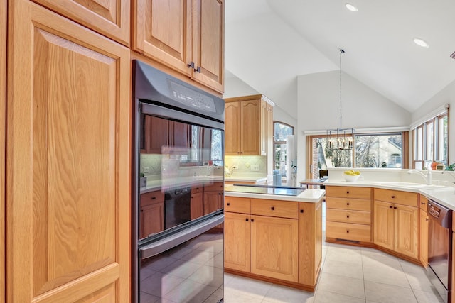 kitchen with light tile patterned flooring, sink, hanging light fixtures, decorative backsplash, and black appliances