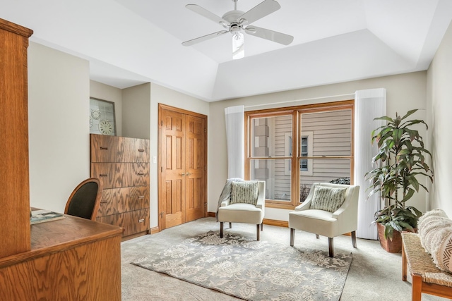 office featuring carpet flooring, ceiling fan, and a tray ceiling