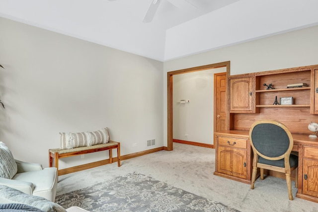 carpeted home office featuring ceiling fan