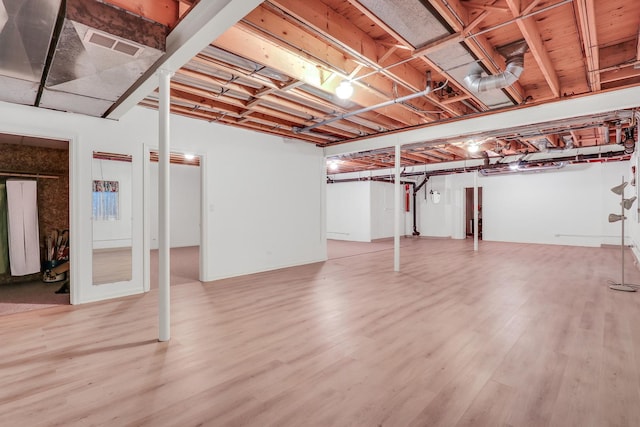 basement featuring hardwood / wood-style floors