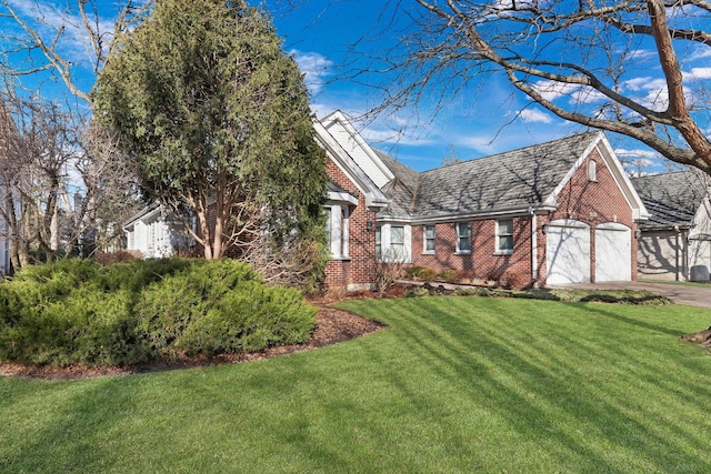 view of front of property with a garage and a front lawn