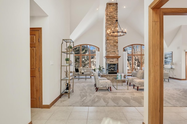 tiled living room featuring an inviting chandelier, a fireplace, and high vaulted ceiling