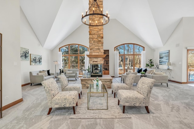 carpeted living room with plenty of natural light, an inviting chandelier, a stone fireplace, and high vaulted ceiling