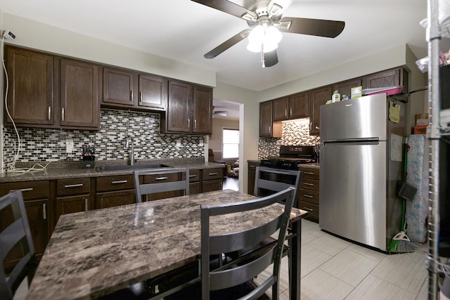 kitchen with stainless steel appliances, dark brown cabinets, sink, and decorative backsplash