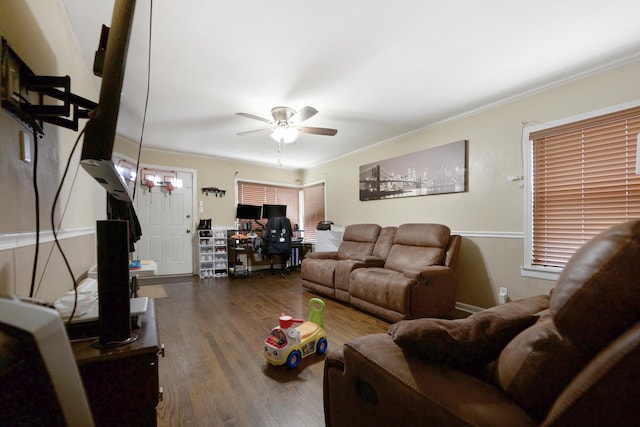 living room with dark hardwood / wood-style flooring, crown molding, and ceiling fan