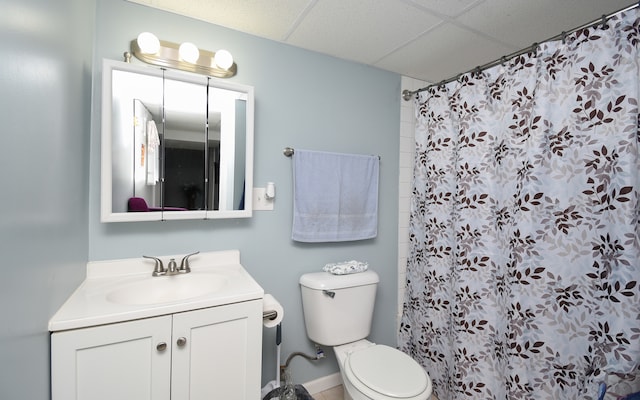 bathroom with vanity, a paneled ceiling, toilet, and a shower with shower curtain