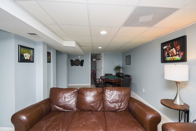 living room with a drop ceiling