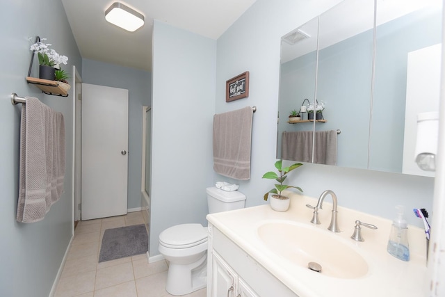 bathroom featuring vanity, tile patterned floors, and toilet