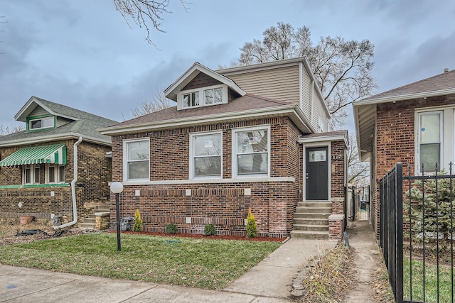 bungalow-style home featuring a front yard