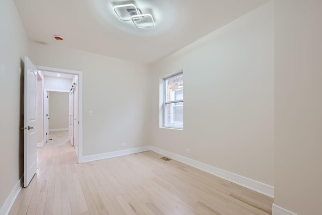 unfurnished room featuring light wood-type flooring