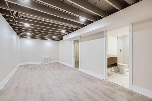 basement with hardwood / wood-style flooring