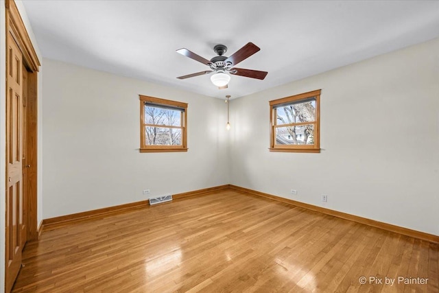 unfurnished bedroom with light wood-type flooring, a closet, multiple windows, and visible vents