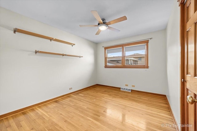 empty room with visible vents, baseboards, light wood-style floors, and a ceiling fan