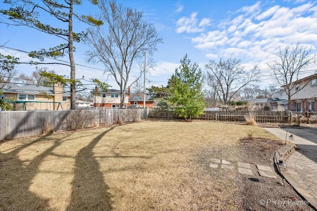 view of yard with a residential view and a fenced backyard