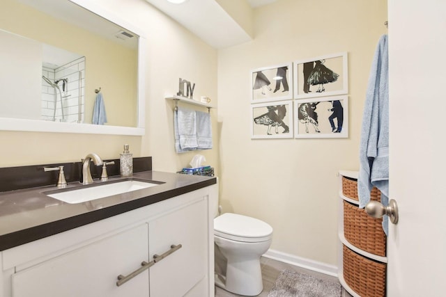 bathroom featuring vanity, wood-type flooring, and toilet