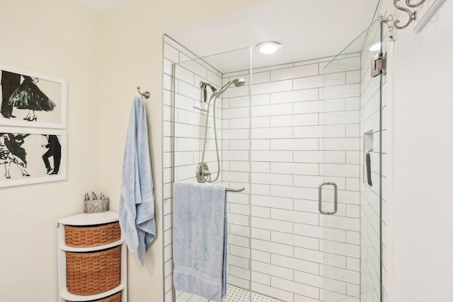 bathroom featuring a shower with shower door