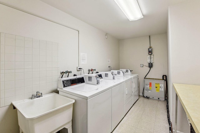 washroom with washing machine and dryer and sink