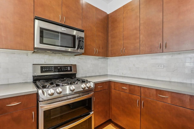 kitchen with stainless steel appliances and decorative backsplash