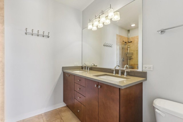 bathroom with vanity, tile patterned floors, toilet, and a shower