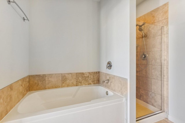 bathroom with shower with separate bathtub